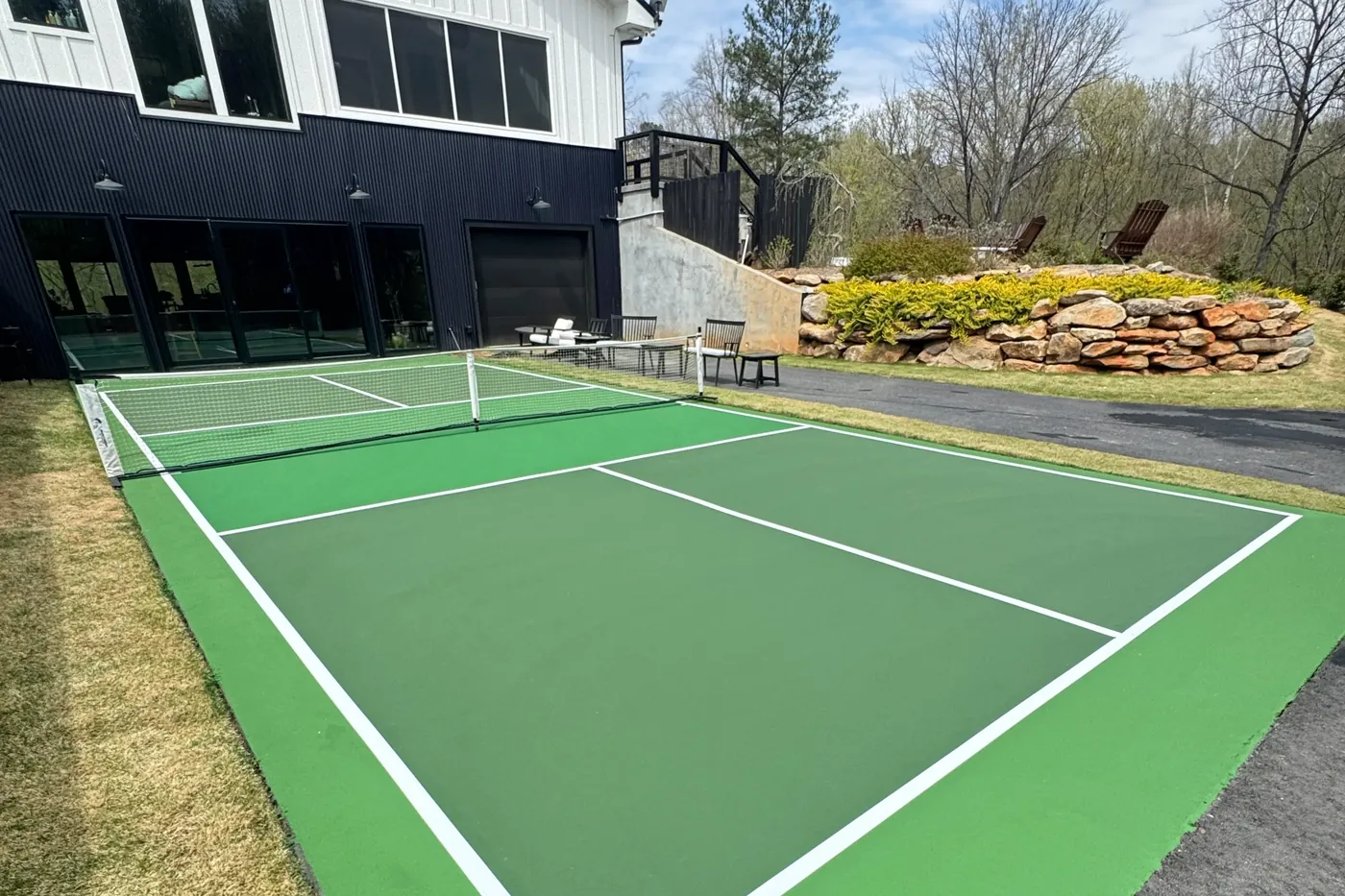 The same backyard after Victory Concrete & Courts installed a finished pickleball court