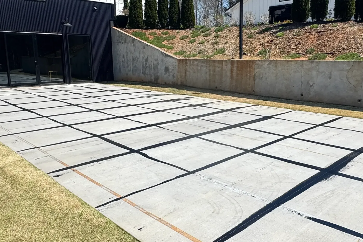 Bare concrete slab in a Metro Atlanta backyard before the court surface was installed